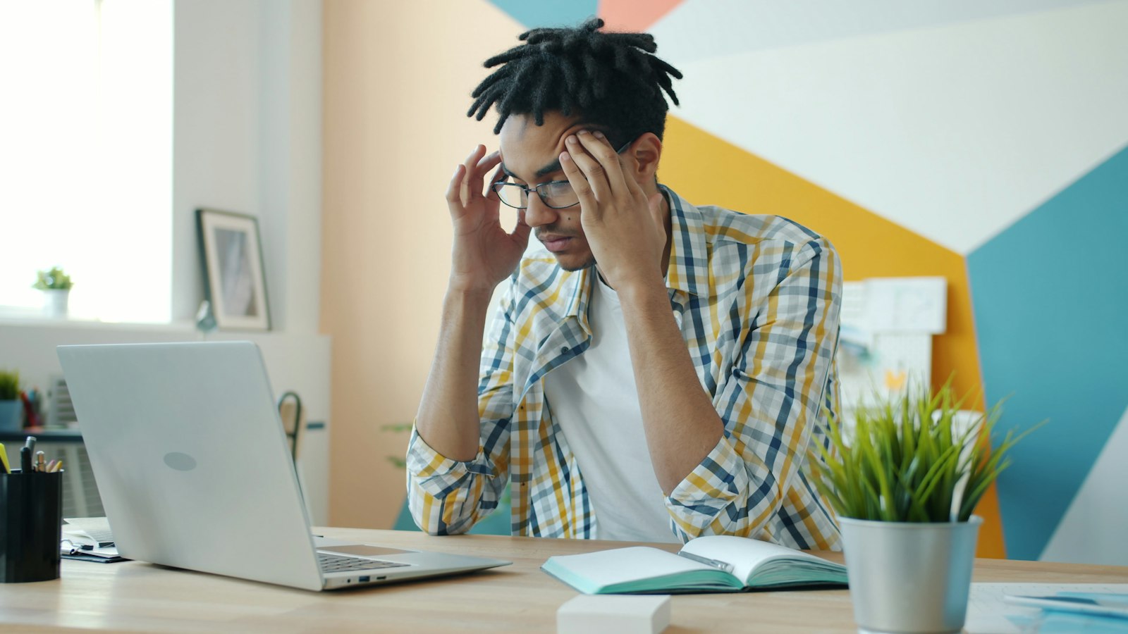 Frustrated employee at a laptop during an internet outage