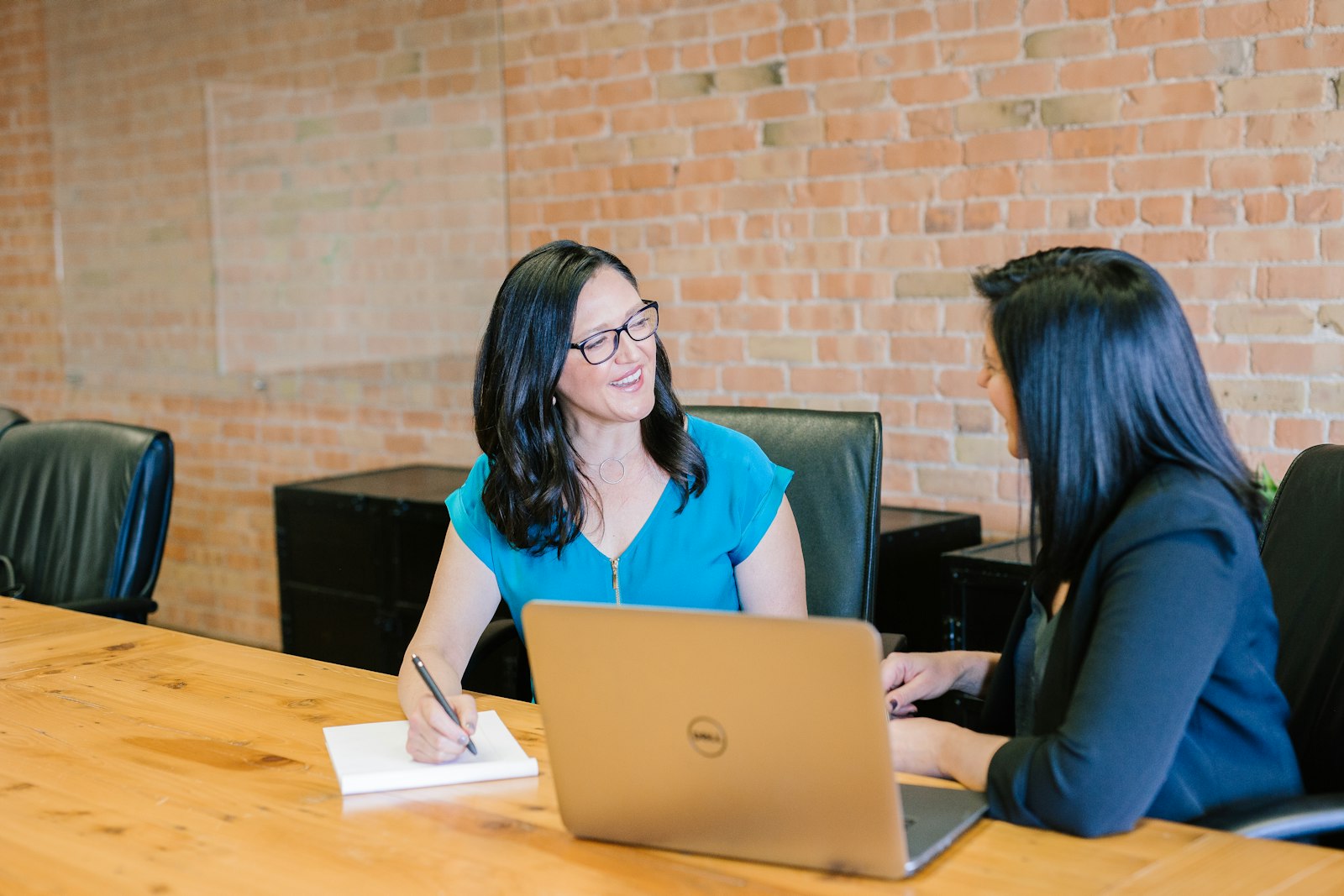Business owner meeting with an IT consultant at a conference table