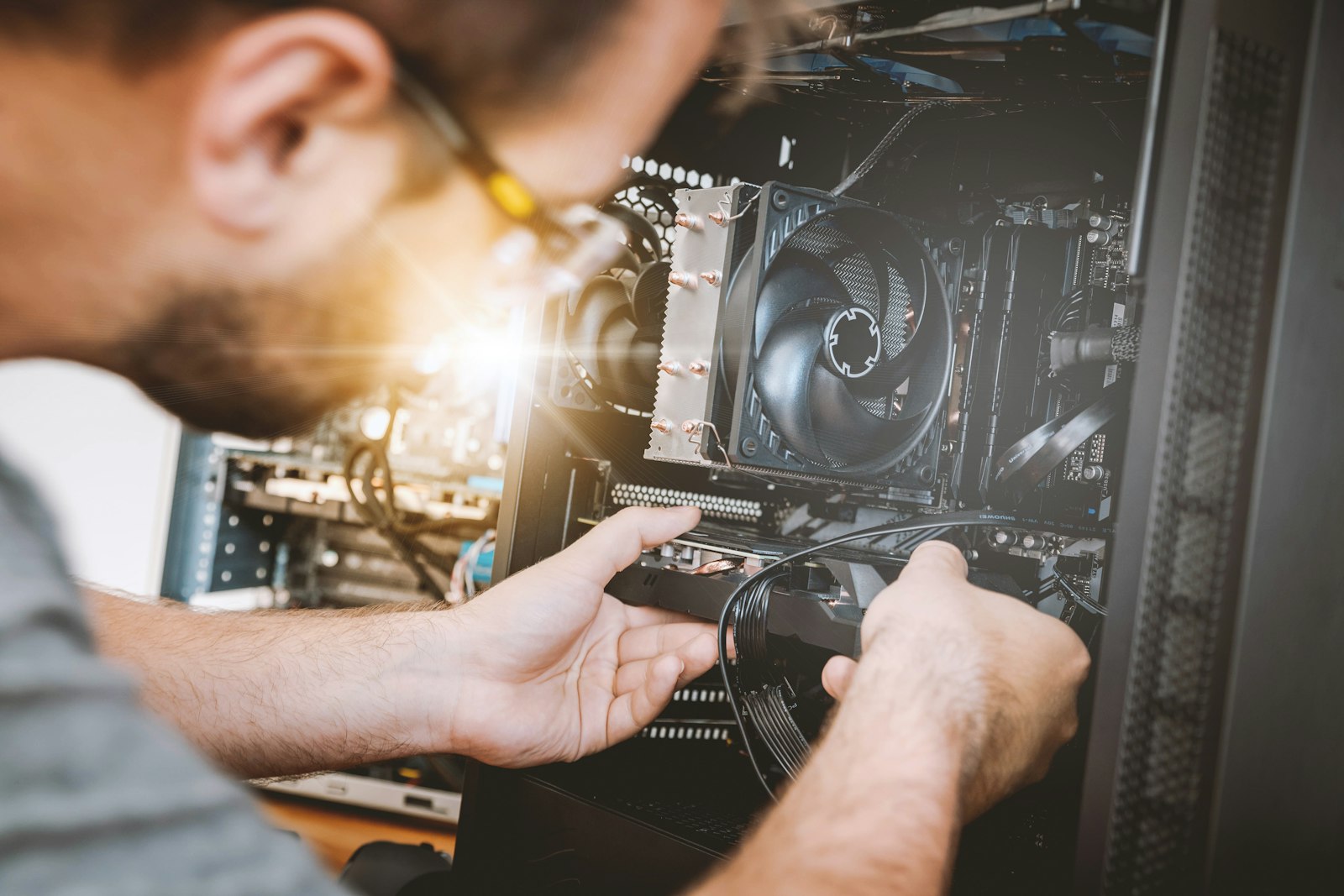 Technician repairing the inside of a desktop computer
