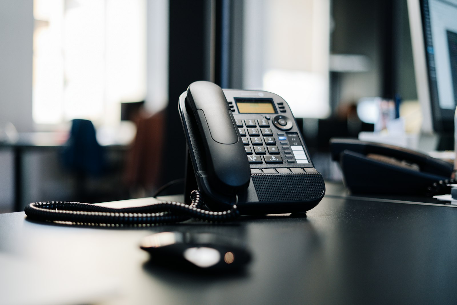 Business VoIP desk phone in a modern office