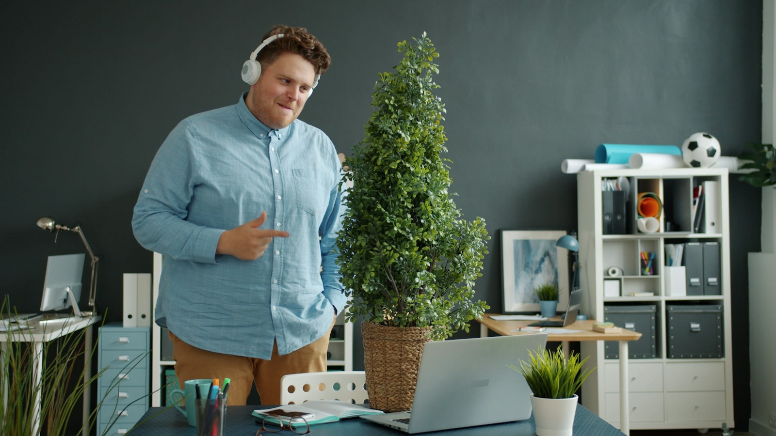 Man on a call with a headset in a small business office